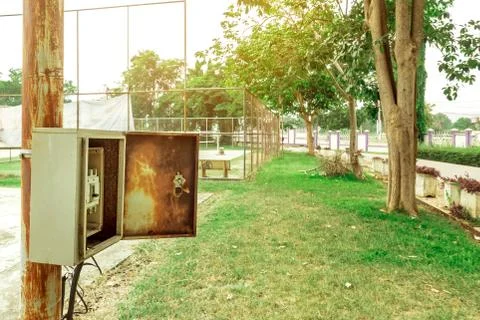 Old rusty electrical power control box on rusted electric pole in the public  Stock Photos