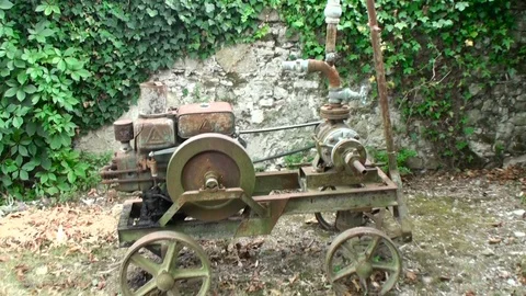 Old rusty frame of a small obsolete, non-working, broken agricultural tractor Stock Footage 108554660
