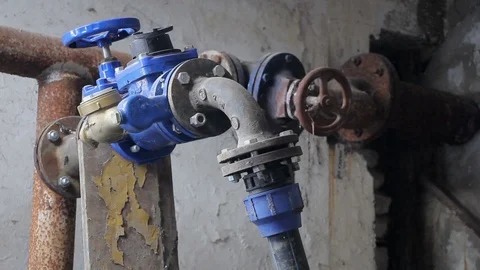 Old rusty gas control valve on the wall. Industrial valve in a large system.  Stock Footage 88988122