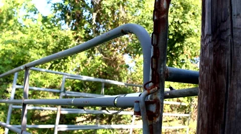 Old rusty gate and a fence post with a chain Stock Footage 52218345
