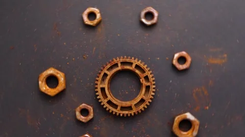 Old rusty gear wheel and bolts rotating on black background Stock Footage 250098665