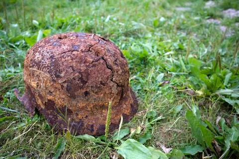 Old rusty german helmet of the Second World War with holes and cracks Stock Photos