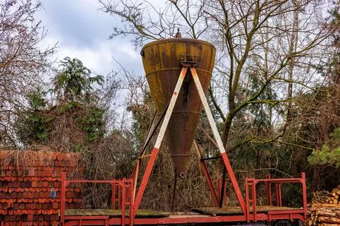 An old, rusty grain storage silo on an open-air platform. Stock Photos