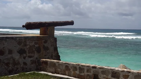 Old, rusty gun stands on the remains of the wall Stock Footage 112139944