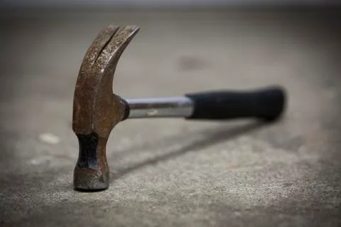 Old rusty hammer lying on the floor Stock Photos