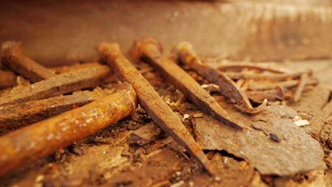 Old rusty hand forged nails pulled out of wood. Close up. Stock Footage 176266779