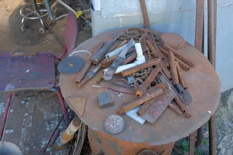 Old rusty hand tools and vintage bench vise in a workshop. Фото