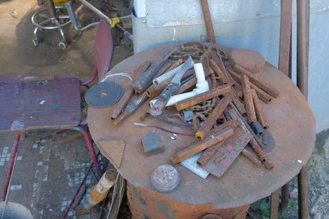 Old rusty hand tools and vintage bench vise in a workshop. Photos
