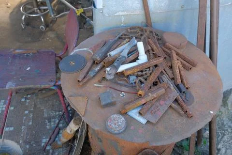 Old rusty hand tools and vintage bench vise in a workshop. Photos