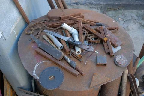 Old rusty hand tools and vintage bench vise in a workshop. Stock Photos