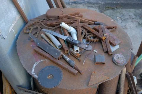 Old rusty hand tools and vintage bench vise in a workshop. Stock Photos