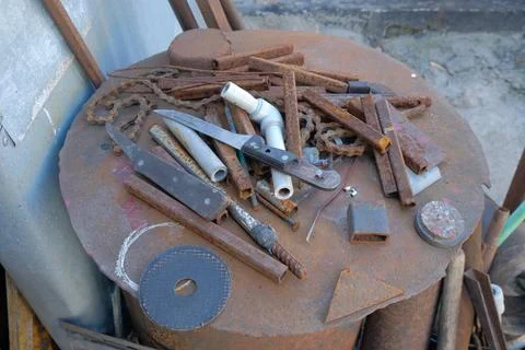 Old rusty hand tools and vintage bench vise in a workshop. Stock Photos