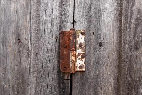 Old rusty hinge on a wooden door. Old rustic background Stock Photos