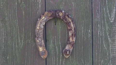 Old rusty horseshoe on a wooden background. Stock Footage 79317232