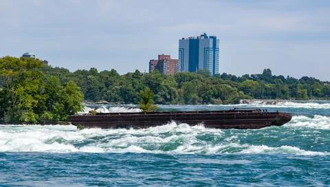 Old rusty iron barge stuck on rocks in a lake near Niagara Falls, Niagara S.. Stock Photos