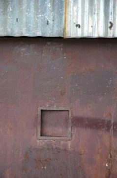 Old rusty iron door with a rectangular box 스톡 사진