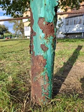 Old rusty iron post with peeling blue paint Фото