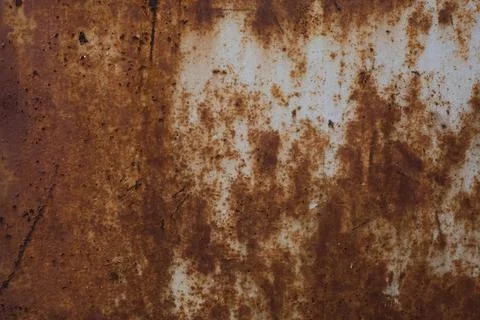Old rusty iron sheet covered with brown rust and grey paint. Background and Stock Photos