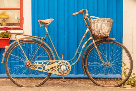 Old rusty lady bicycle in front of a Swedish house Stock Photos