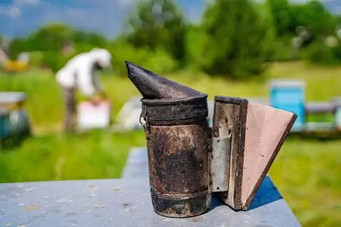 Old rusty lantern and notebook on a table outdoors Stock Photos