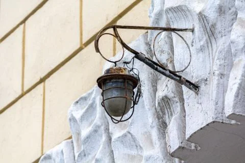 Old rusty lantern hanging on a wall of the house Stock Photos