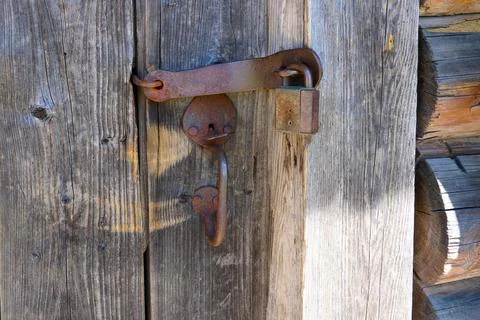 Old rusty lock and iron door handle of a wooden house Photos