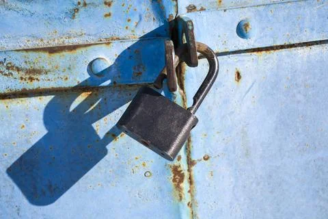 Old rusty lock on the door. Old soviet door with a lock. Garage doors, vertical Stock Photos