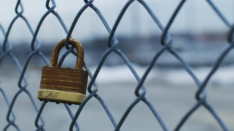 Old rusty lock on fence Stock Footage 100048846