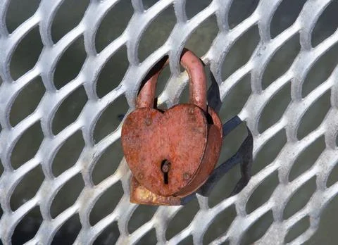 Old rusty lock on the grate Stock Photos