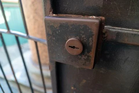 Old rusty lock securing a metal gate, protecting property and privacy Stock Photos