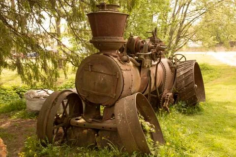 Old rusty machine near the trees Photos