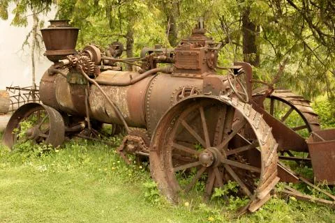 Old rusty machine near the trees Photos