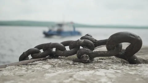 Old rusty metal chain on blurred background of river in floating ship. Close-up. Stockbeeldmateriaal 247177673