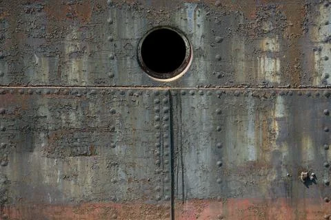 Old rusty metal texture, part of a ship, with screws Stock Photos