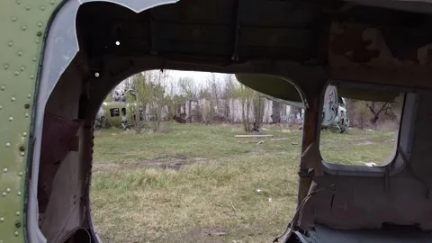Old rusty military helicopter in a clearing Stock Footage