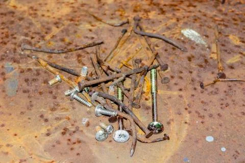 Old rusty nails and screws on rusty background and texture Stock Photos