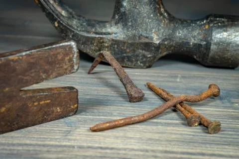 Old rusty nails with two claw hammers Stock Photos