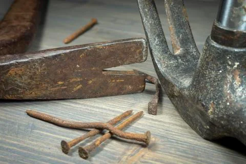 Old rusty nails with two claw hammers Stock Photos
