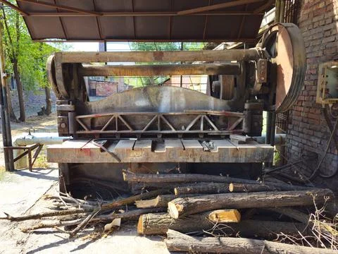 An old, rusty, non-working metal cutting machine. Stock Photos