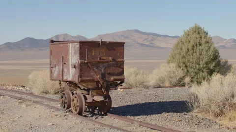 Old Rusty Ore Cart Sitting on Rail Tracks in Nevada Desert - Shallow DOF Stock Footage 144655187