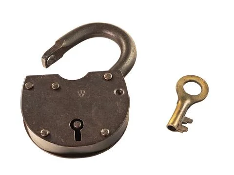 Old rusty padlock with a key is open isolated on a white Stock Photos