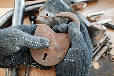 Old, rusty padlock in a man's hands. 스톡 사진