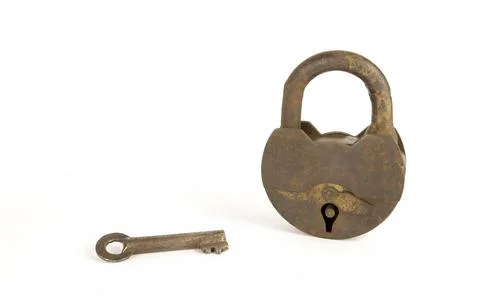 An old rusty padlock on a white background. A key for the lock. 스톡 사진
