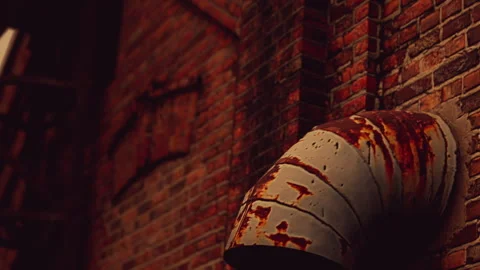 Old rusty pipe against a brick wall in an urban setting Stock Footage 337875826