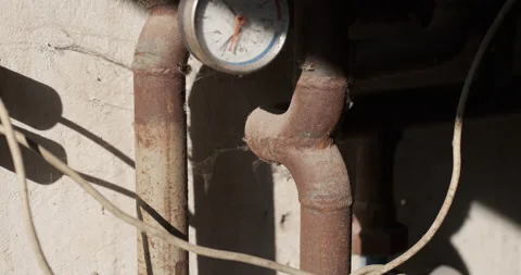 Old rusty pipe with an analog meter gauge Stock Footage 165506897