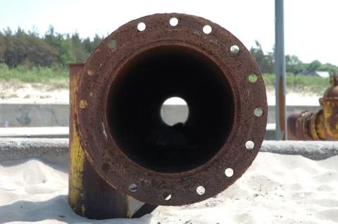 Old rusty pipe on the beach Stock Photos
