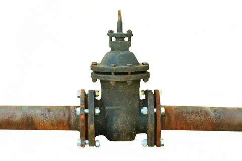Old rusty pipe with shut-off valve over green grass Stock Photos