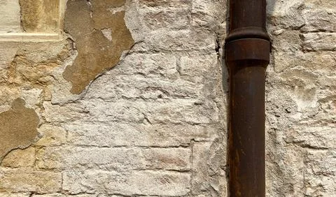 Old rusty pipe on a stone wall Stock Photos