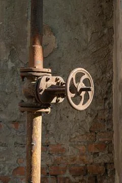 Old rusty pipe with valve, close-up. Stock Photos