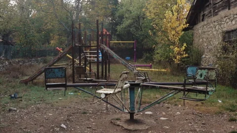 Old rusty playground equipment in an abandoned area Stock Footage 336306638